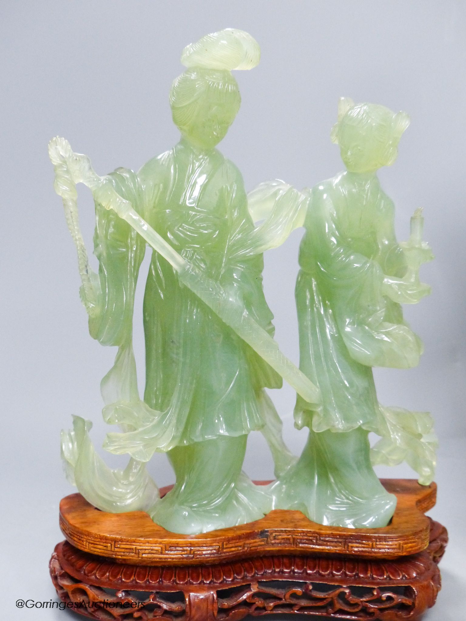 A pair of cased Chinese bowenite jade figure carvings and a porcelain figure of Guanyin, height 33cm
